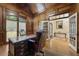 Elegant wood paneled office with hardwood floors, double windows and glass doors at 8970 Moor Park Run, Duluth, GA 30097