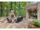 Relaxing outdoor stone patio features a fireplace, seating area, and access to the covered patio at 8970 Moor Park Run, Duluth, GA 30097