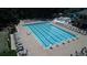Aerial view of resort style community pool with swim lanes, pool furniture, wading pool and shade umbrellas at 8970 Moor Park Run, Duluth, GA 30097