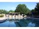 Resort style community pool with pergola, pool furniture, mature trees and shade umbrellas at 8970 Moor Park Run, Duluth, GA 30097
