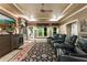 Home theater room with tiered seating, large screen, and custom window treatments at 8970 Moor Park Run, Duluth, GA 30097