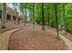 Well-maintained yard with gravel and stone pathways, mature trees, and meticulous landscaping at 8970 Moor Park Run, Duluth, GA 30097