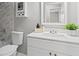 Bathroom featuring a white vanity, mirror, cabinet and tiled wall above the bathtub at 1360 Terramont Dr, Roswell, GA 30076