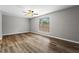 Spacious bedroom features hardwood floors, ceiling fan, and a large window for natural light at 1360 Terramont Dr, Roswell, GA 30076