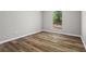Bright bedroom featuring stylish wood flooring and a window view to the outdoors at 1360 Terramont Dr, Roswell, GA 30076