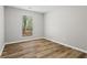 Bright bedroom featuring stylish wood flooring and a window view to the outdoors at 1360 Terramont Dr, Roswell, GA 30076