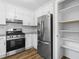 Bright kitchen features white cabinetry, granite countertops, stainless appliances, and a pantry at 1360 Terramont Dr, Roswell, GA 30076