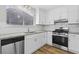 Contemporary kitchen features stainless steel appliances, granite counters, and white cabinets at 1360 Terramont Dr, Roswell, GA 30076