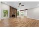 The spacious living room features a stone fireplace, ceiling fan, and sliding glass doors to the backyard at 1360 Terramont Dr, Roswell, GA 30076