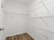 Walk-in closet features wire shelving and wood floors for ample storage space at 1360 Terramont Dr, Roswell, GA 30076