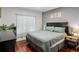 Comfortable bedroom featuring hardwood floors, a large window and a queen bed with decorative pillows at 2700 Pine Tree Rd # 3006, Atlanta, GA 30324