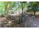 Community dog park with benches and waste station surrounded by mature trees in a fenced area at 2700 Pine Tree Rd # 3006, Atlanta, GA 30324