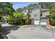Attractive multi-story townhome with garages, red doors, and mature trees in a quiet, well-maintained community at 2700 Pine Tree Rd # 3006, Atlanta, GA 30324