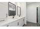 Modern bathroom featuring double sinks, framed mirrors, and sleek fixtures with a tile shower at 367 Parkway Ne Dr # 5, Atlanta, GA 30312