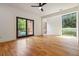 Bright bedroom with hardwood floors, large windows, and a sliding glass door with a black frame at 367 Parkway Ne Dr # 5, Atlanta, GA 30312