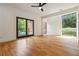 Bedroom features wood floors, a ceiling fan, large windows, and glass sliding doors at 367 Parkway Ne Dr # 5, Atlanta, GA 30312