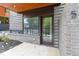 A modern townhome exterior entrance featuring a brick facade, large window, and recessed lighting at 367 Parkway Ne Dr # 5, Atlanta, GA 30312