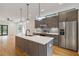 Modern kitchen features an island with a white countertop, wood cabinets, and stainless steel appliances at 367 Parkway Ne Dr # 5, Atlanta, GA 30312