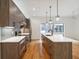 Modern kitchen featuring stainless steel appliances, stylish pendant lights, and a large island with seating at 367 Parkway Ne Dr # 5, Atlanta, GA 30312