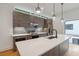 Modern kitchen featuring stainless steel appliances, stylish pendant lights, and a large island with seating at 367 Parkway Ne Dr # 5, Atlanta, GA 30312