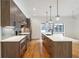 Modern kitchen features an island with a white countertop, wood cabinets, and stainless steel appliances at 367 Parkway Ne Dr # 5, Atlanta, GA 30312