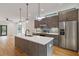 Modern kitchen featuring stainless steel appliances, stylish pendant lights, and a large island with seating at 367 Parkway Ne Dr # 5, Atlanta, GA 30312