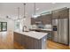 Modern kitchen featuring stainless steel appliances, stylish pendant lights, and a large island with seating at 367 Parkway Ne Dr # 5, Atlanta, GA 30312