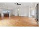 Spacious open-concept living area with hardwood floors, modern lighting, and access to kitchen and staircase at 367 Parkway Ne Dr # 5, Atlanta, GA 30312