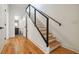 Staircase featuring a wooden handrail, and modern design with wood floors and a view of the bathroom at 367 Parkway Ne Dr # 5, Atlanta, GA 30312