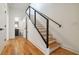 Staircase features wood steps, wood floor, a black railing, and a view into the bathroom at 367 Parkway Ne Dr # 5, Atlanta, GA 30312