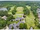 Overhead view highlighting the golf course and clubhouse nestled within a lush, green landscape at 5365 Glenhaven Dr, Cumming, GA 30041