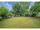 Large, well-maintained backyard with mature trees offering shade and privacy at 5365 Glenhaven Dr, Cumming, GA 30041