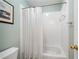 Clean, white bathroom featuring a bathtub with shower and classic fixtures at 5365 Glenhaven Dr, Cumming, GA 30041
