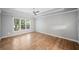 Bright bedroom with a large window, a ceiling fan, and light-colored wood floors at 5365 Glenhaven Dr, Cumming, GA 30041