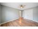 Bright bedroom features a ceiling fan, hardwood floors, and a large closet at 5365 Glenhaven Dr, Cumming, GA 30041