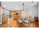 Sunlit dining area showcases wood floors, stainless appliances, and adjacent kitchen island at 5365 Glenhaven Dr, Cumming, GA 30041
