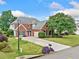 Charming brick home featuring a well-manicured lawn, lush landscaping, and a long driveway at 5365 Glenhaven Dr, Cumming, GA 30041