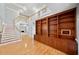 Inviting foyer featuring wood floors, high ceilings, built-in shelving, staircase and fireplace at 5365 Glenhaven Dr, Cumming, GA 30041