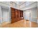 Spacious foyer with built-in shelving, light hardwood floors, high ceilings, and plenty of natural light at 5365 Glenhaven Dr, Cumming, GA 30041