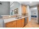 Modern kitchen with wood cabinets, stainless appliances, quartz countertops, and seamless access to dining area at 5365 Glenhaven Dr, Cumming, GA 30041