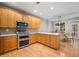Well-appointed kitchen features stainless appliances, tile backsplash, and adjacent dining area with light from door at 5365 Glenhaven Dr, Cumming, GA 30041