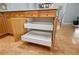 Pull out drawers reveal ample storage within the light wood kitchen island at 5365 Glenhaven Dr, Cumming, GA 30041