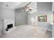 Cozy living room with a fireplace, neutral carpet, vaulted ceiling and adjacent breakfast nook at 5365 Glenhaven Dr, Cumming, GA 30041