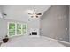 Spacious living room with neutral carpet, fireplace, vaulted ceiling, and large windows at 5365 Glenhaven Dr, Cumming, GA 30041