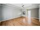 Spacious living room features a fireplace and light-colored wood flooring at 5365 Glenhaven Dr, Cumming, GA 30041