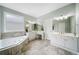 Bright bathroom with soaking tub, double vanity, and neutral tile flooring at 5365 Glenhaven Dr, Cumming, GA 30041