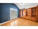 Cozy office with blue walls, hardwood floors, built-in shelves, and plantation shutters at 5365 Glenhaven Dr, Cumming, GA 30041