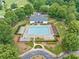 Aerial view of community pool with manicured landscaping, seating areas, and mature trees at 5365 Glenhaven Dr, Cumming, GA 30041
