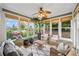 Inviting sunroom filled with lush plants and comfortable wicker furniture at 5365 Glenhaven Dr, Cumming, GA 30041