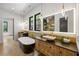 Luxurious bathroom featuring dual vanities, a freestanding tub, and modern pendant lighting at 942 Fairfield, Marietta, GA 30068
